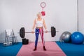 patriotic senior sportswoman lifting barbell and smiling