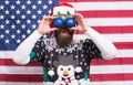 Patriotic surprise. Surprised hipster hold baubles as glasses. Bearded man look with surprise. Santas surprise