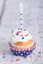 Patriotic 4th of July cupcake with candle Royalty Free Stock Photo