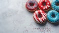 Patriotic-Themed Donuts with Red, White, and Blue Icing on Textured Background Royalty Free Stock Photo