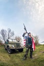 Patriotic young woman with rifle, american flag and car Royalty Free Stock Photo