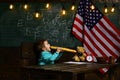 Patriotism and freedom. Little boy eat bread at American flag at knowledge day. Back to school or home schooling. Happy Royalty Free Stock Photo