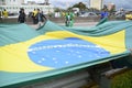 Patriots hold the huge flag of Brazil at the demonstration on the via dutra