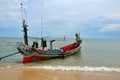 Sea going fishing vessel boat parked on beach in Pattani village Thailand