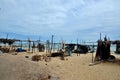 Wood and bamboo palm leaf shacks by seaside in fishing village Pattani Thailand