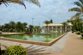 Fountain beside Pattani Central mosque and building with arches Thailand