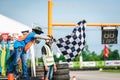 PATTATA,THAILAND-September 02:The competition committee is waving checker flag to the finish line.Go Kart race at the finishing p Royalty Free Stock Photo
