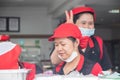 two good-humored Thai women work in a restaurant in Thailand