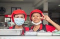 two good-humored Thai women work in a restaurant in Thailand