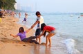 Two girls and a young man having fun on the city beach in Pattaya Royalty Free Stock Photo