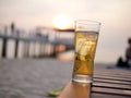 Pattaya, Thailand, 09  Februar :A glass of Budweiser, cold beer on a wooden table beside a beautiful sandy beach on a tropical sea Royalty Free Stock Photo