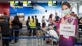 PATTAYA, THAILAND - FEBRUARY 4, 2020: air hostess welcome standee wearing protect mask at check-in area, U-Tapao airport