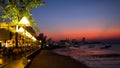 PATTAYA, THAILAND - January 14 - 2018: Coastal Restaurant and Fishing boats at coastal in sunset. The back of Pattaya city