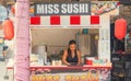 A young Thai woman was preparing sushi in a small snack bar in Pattaya