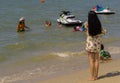 PATTAYA,THAILAND - OCTOBER 23,2018:The beach Thai kids and young women have fun on the beach
