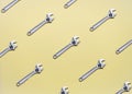 The pattern of adjustable wrenches on a yellow background.