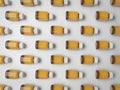 Pattern of amber glass vials with white caps on a white background Royalty Free Stock Photo