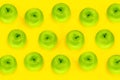 Pattern apples. Fresh and juicy green apples on the yellow color background, top view