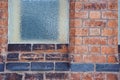 Pattern background image of frosted window on old redbrick wall with line of black bricks