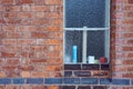 Pattern background image of frosted window on old redbrick wall with line of black bricks