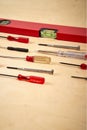 Pattern background of various screwdrivers with spirit level on wooden work table