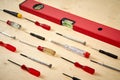 Pattern background of various screwdrivers with spirit level on wooden work table