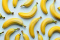 Pattern with bananas, top view, flat lay. Tropical abstract background. Banana on yellow background. Colorful fruit pattern, Royalty Free Stock Photo