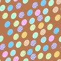 A pattern of multicolored Easter eggs of different sizes on a beautiful brown background