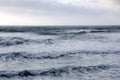 Pattern of big waves at sea in cloudy sky Royalty Free Stock Photo