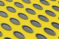 Pattern of black oval plates on yellow background