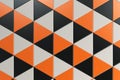 Pattern of black, white and orange triangle prisms