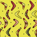 A pattern of boomerangs of different shapes and with different patterns on a yellow background. Traditional souvenir and