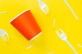 Pattern of broken plastic forks, and plastic cup on a yellow background. Royalty Free Stock Photo