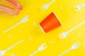 Pattern of broken plastic forks, plastic cup and bag on a yellow background. Royalty Free Stock Photo