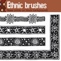 Ethnic brushes. Suns white on black background