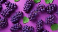 Pattern of bunch of red grapes with green leaves on purple background. Royalty Free Stock Photo