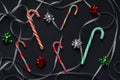 Pattern of candy cane christmas, swirls of silver ribbon and bows for gifts green, red and silver colors. New Year decorations Royalty Free Stock Photo