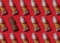 Pattern chocolate Santa Claus on a red background. Sweet Christmas candy. Sweet food for the holiday. Treat