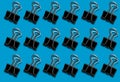 Pattern with a clerical clip on a blue background Royalty Free Stock Photo
