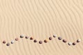 Pattern of colored pebbles on clean sand. Zen background, harmony and meditation concept Royalty Free Stock Photo