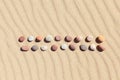 Pattern of colored pebbles on clean sand. Zen background, harmony and meditation concept Royalty Free Stock Photo