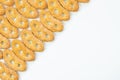 Pattern of cookies ears on a white background, sweet pretzels, top view, isolated, in a close-up