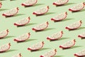 Pattern created from fresh exotic dragon fruit slices on brigh green background