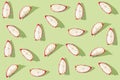 Pattern created from fresh exotic dragon fruit slices on brigh green background. Top view Royalty Free Stock Photo