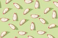 Pattern created from fresh exotic dragon fruit slices on pastel green background. Top view Royalty Free Stock Photo