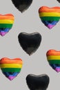 Pattern created of many rainbow and black heart shaped balloons. Gray background. Diversity, LGBT and black lives matters