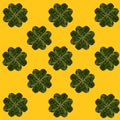 Pattern created of minimal lucky shamrock arranged from hearts formed of fresh green leaves from Irish woods. Clovers shape leaves