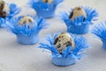 Pattern of decorated quail eggs in the form of blue flowers on a background of natural linen fabric. Children`s creativity, craft