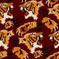 A pattern at different angles of a vector image of a tiger's head and a paw cutting the material, on a red