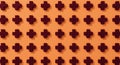 A pattern features dark red crosses arranged uniformly on a light orange background. Royalty Free Stock Photo